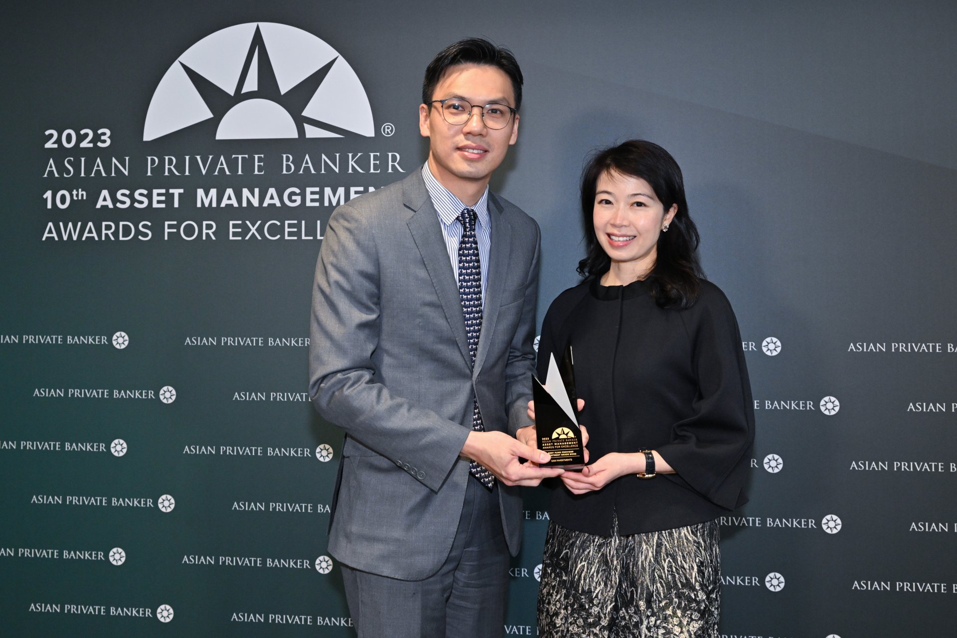 Jeff Wong and Genevieve Chan of GAM Investments collect their trophy for Best Fund Provider - Investment Grade Bond
